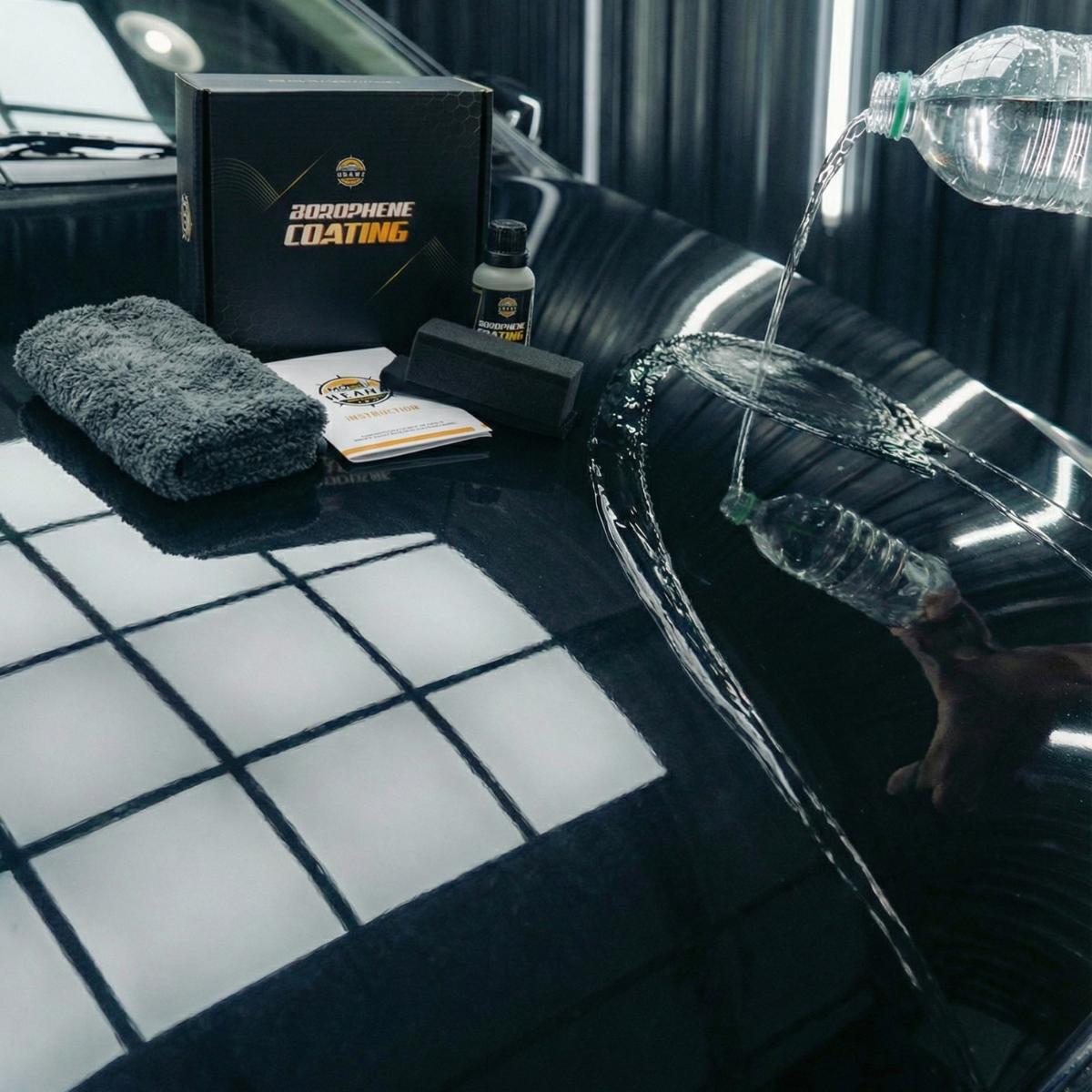 Shiny black car surface with water being rinsed, car detailing products, microfiber towel, and polishing tools at Motor Headz.