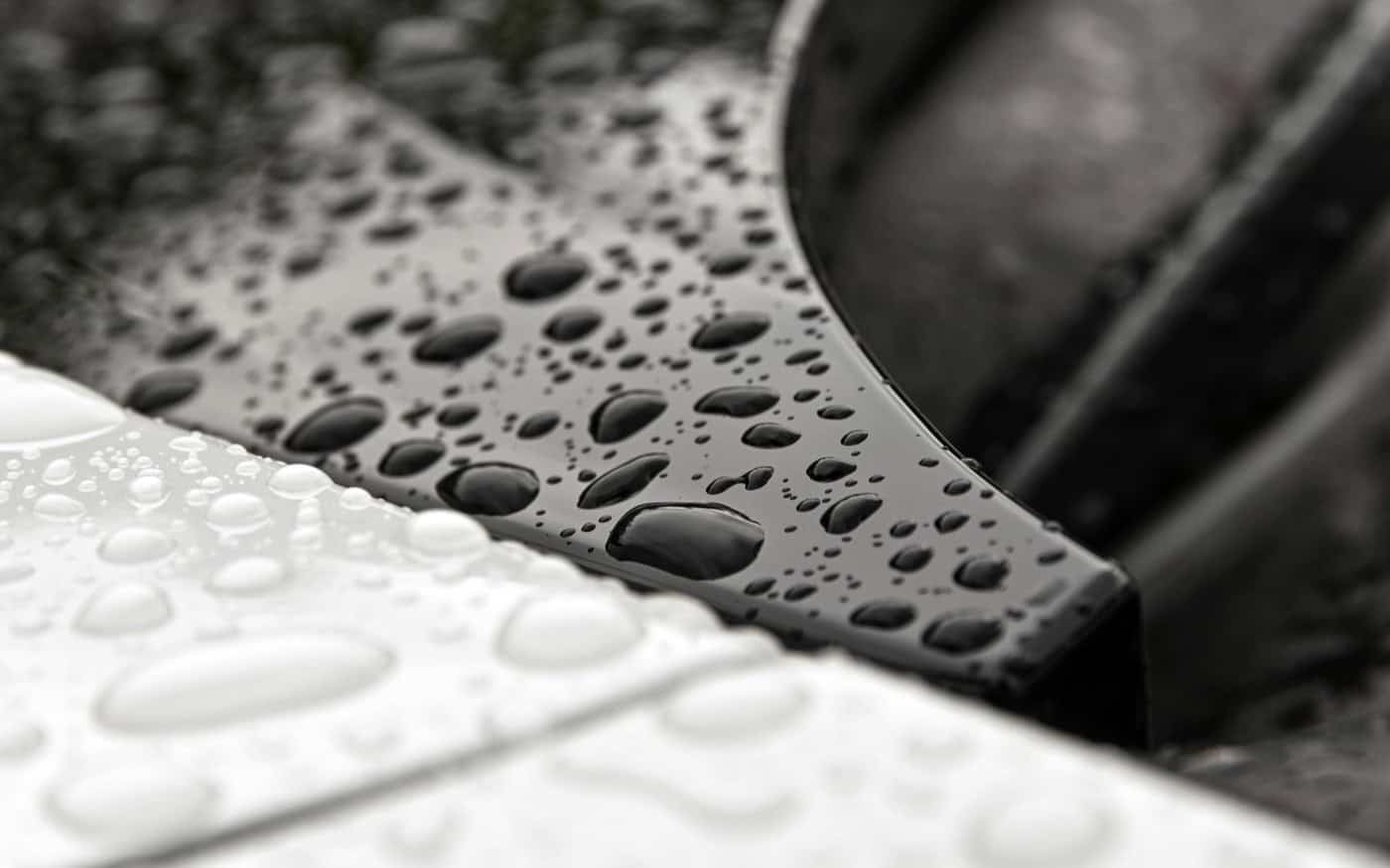 Water droplets on a car panel illustrating hydrophobic beading